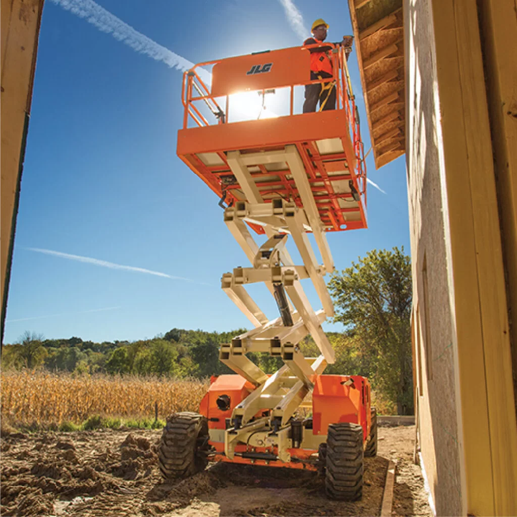 JLG rough terrain scissor lift repairing house
