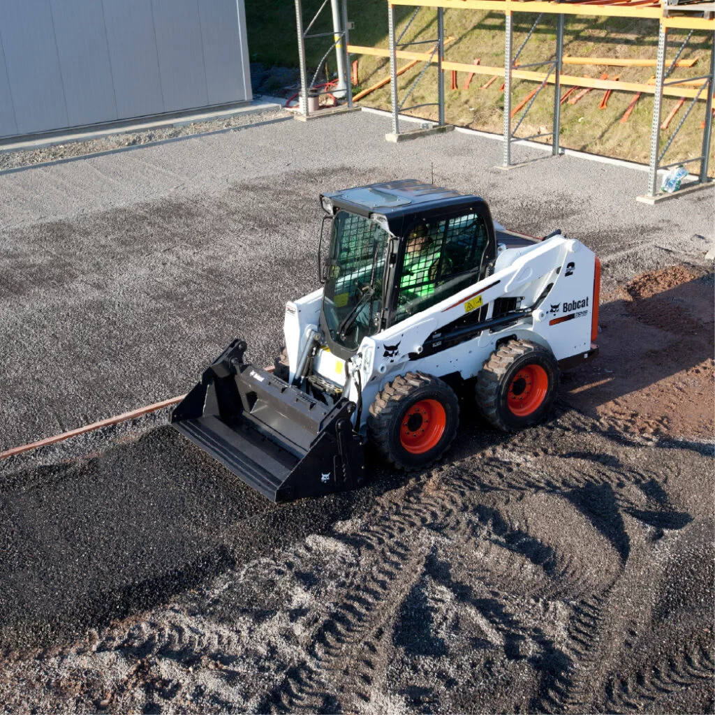 bobcat skid steer loader fixing asphalt