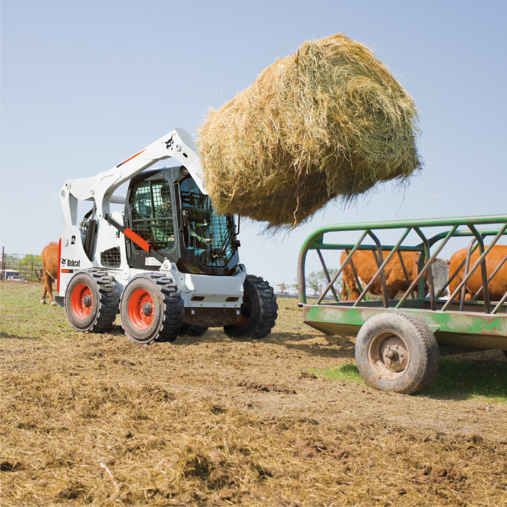 bobcat skid steer loader lifting hay