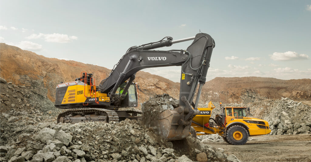 volvo ec950fl and hauler in construction site