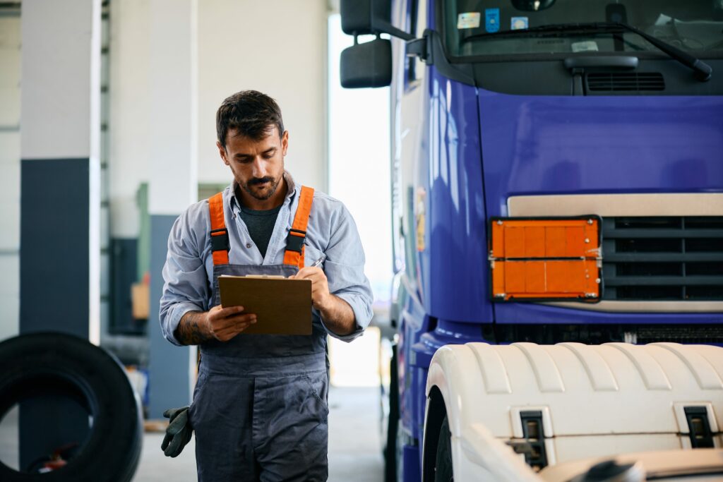 an operator doing maintenance on his truck