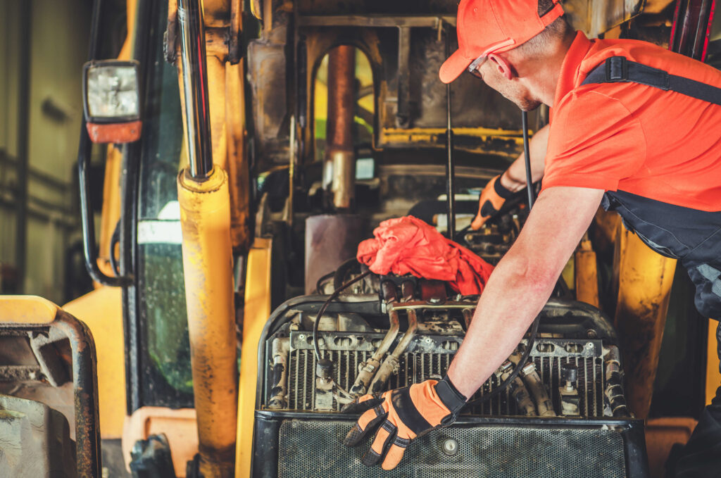 A mechanic repairing heavy equipment.